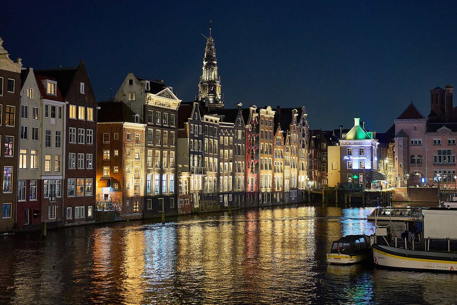 Amsterdamse gracht met grachtenpanden bij avond